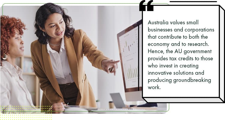 Two business colleagues working out tax relief and the company tax rate Australia implements.